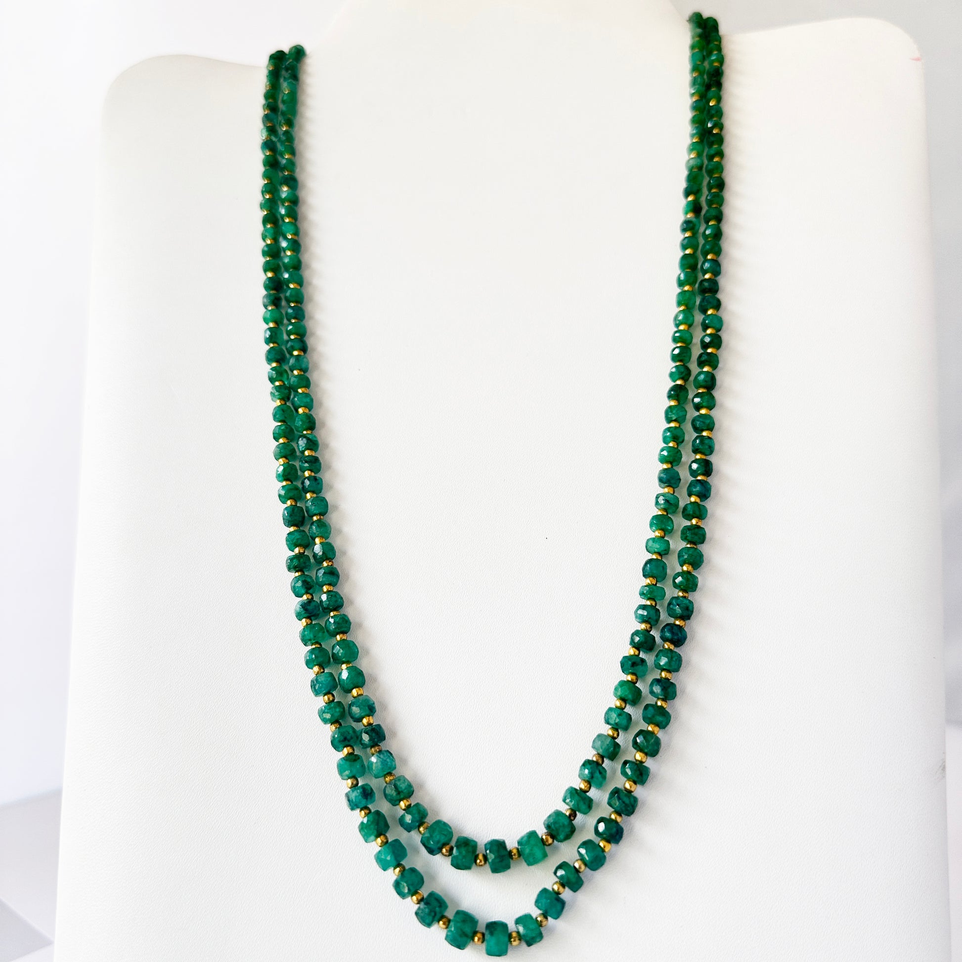 Two-strand beryl emerald necklace with adjustable silk tassel, crafted from polished natural gemstone beads.