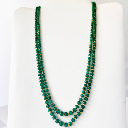 Two-strand beryl emerald necklace with adjustable silk tassel, crafted from polished natural gemstone beads.