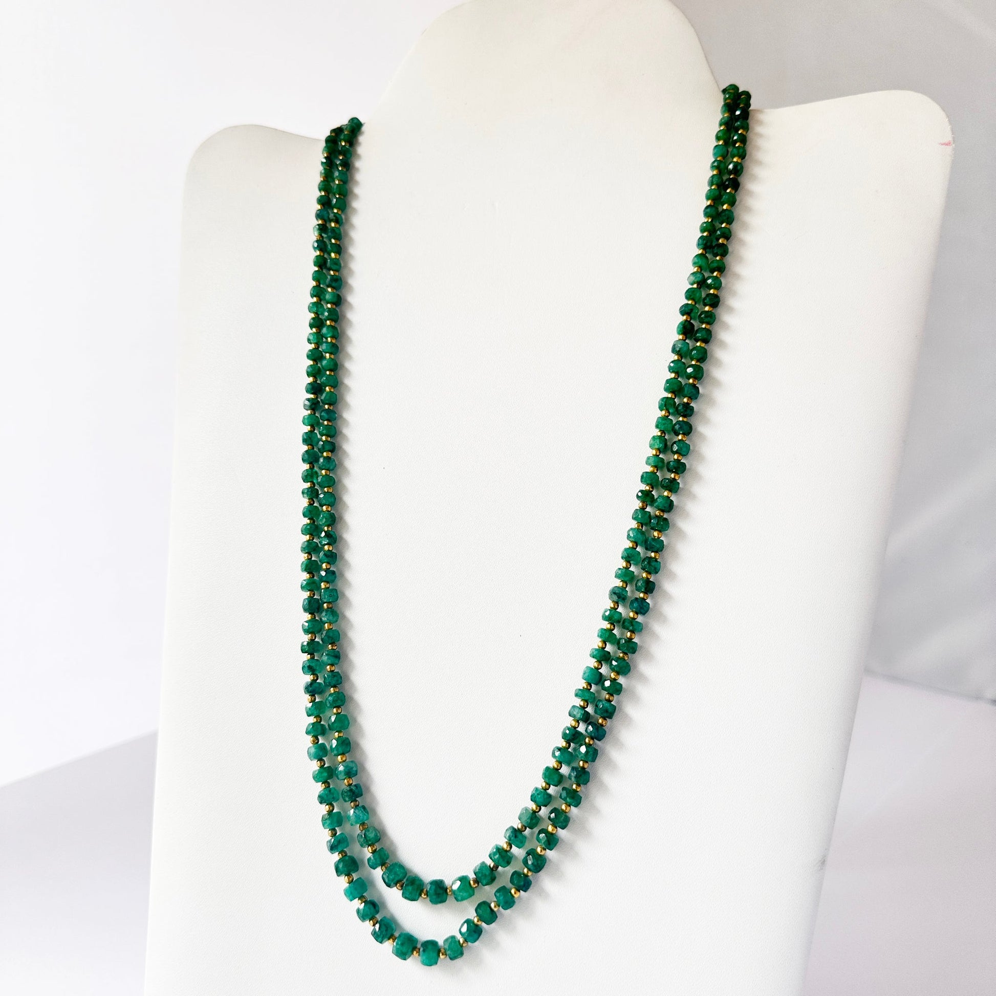 Necklace with delicate strands of Beryl Emerald beads, showcasing their smooth design.