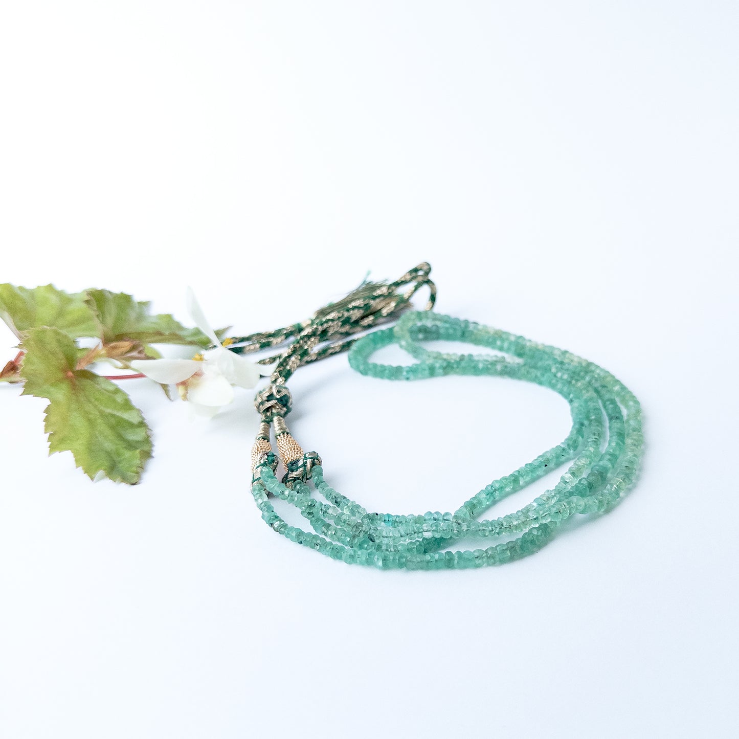 Close up of Beryl gemstone beads showing pastel tones and faceted rondelle shine for jewellery designers.