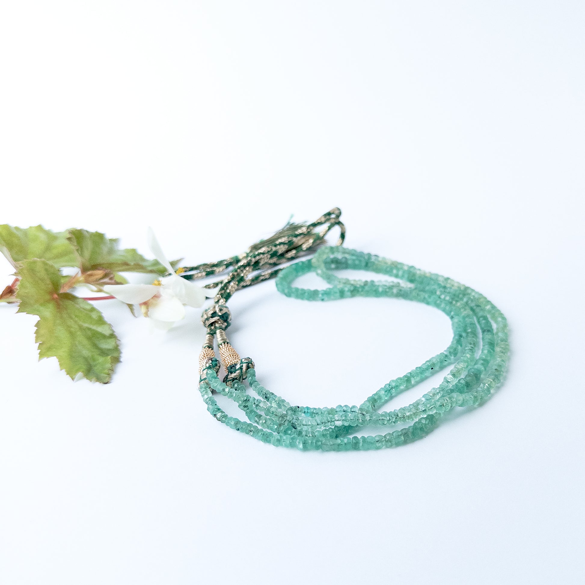 Close up of Beryl gemstone beads showing pastel tones and faceted rondelle shine for jewellery designers.