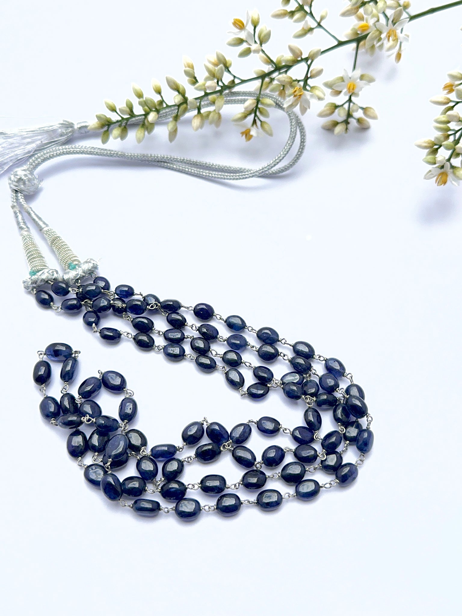 Blue sapphire necklace with smooth oval beads showing shine and rich colour.