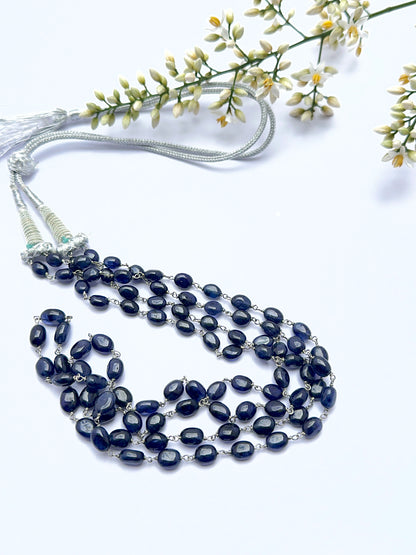 Blue sapphire necklace with smooth oval beads showing shine and rich colour.