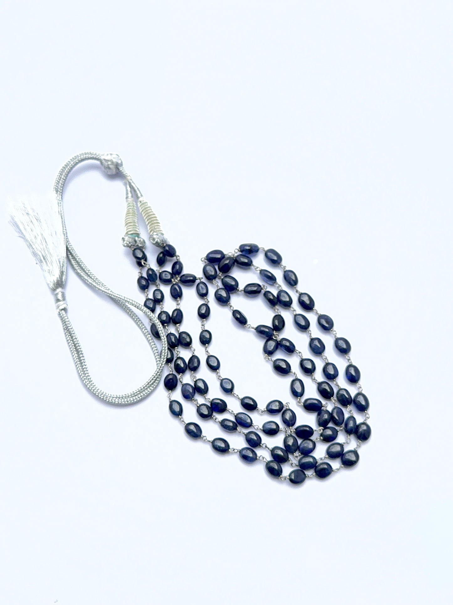 Elegant sapphire necklace featuring oval beads arranged in a refined layered design.
