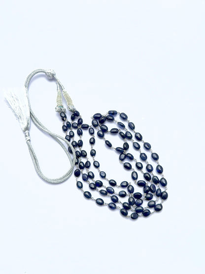 Elegant sapphire necklace featuring oval beads arranged in a refined layered design.