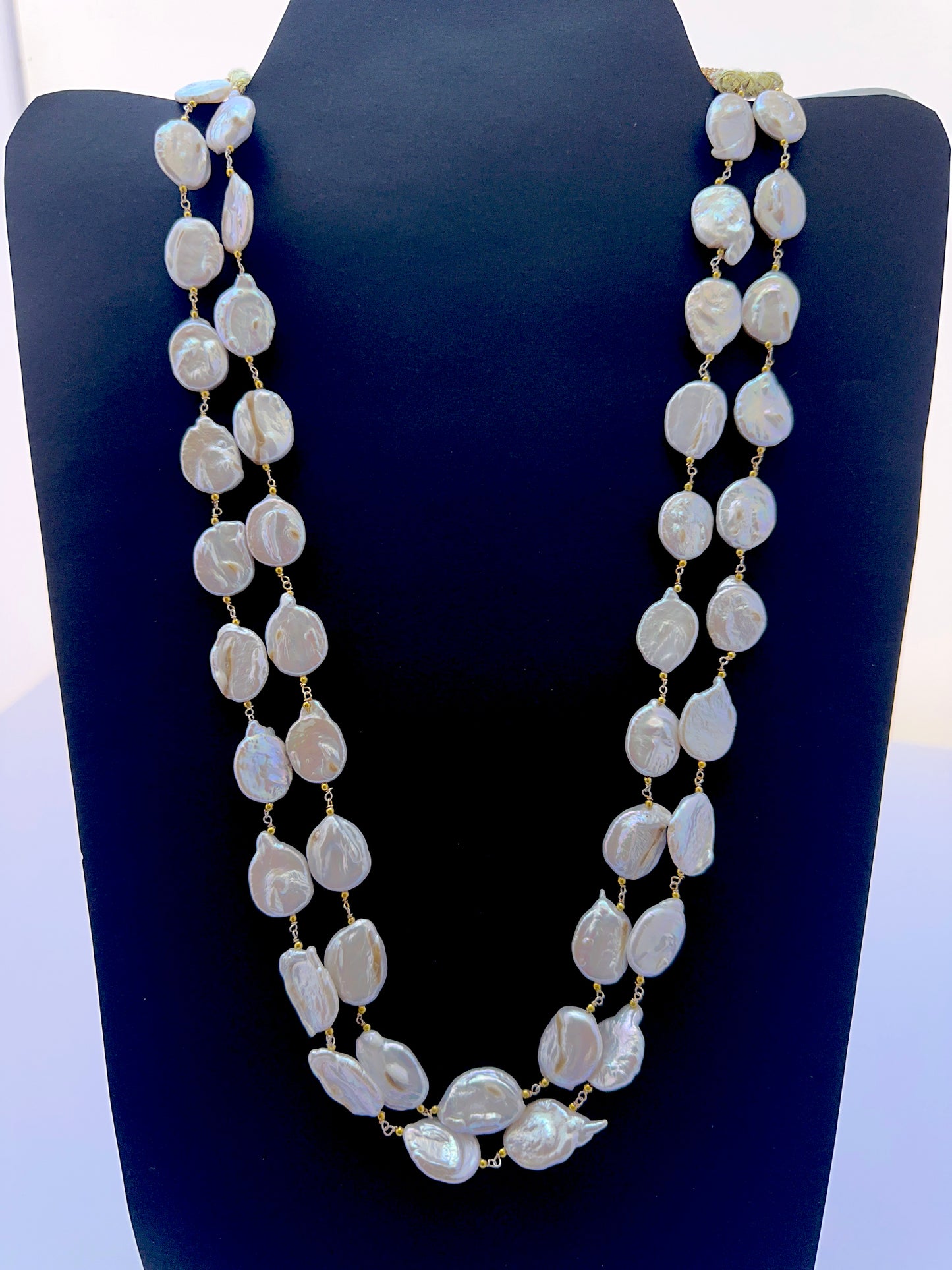Elegant pearl necklace featuring large baroque coin pearls in a bold layered design.