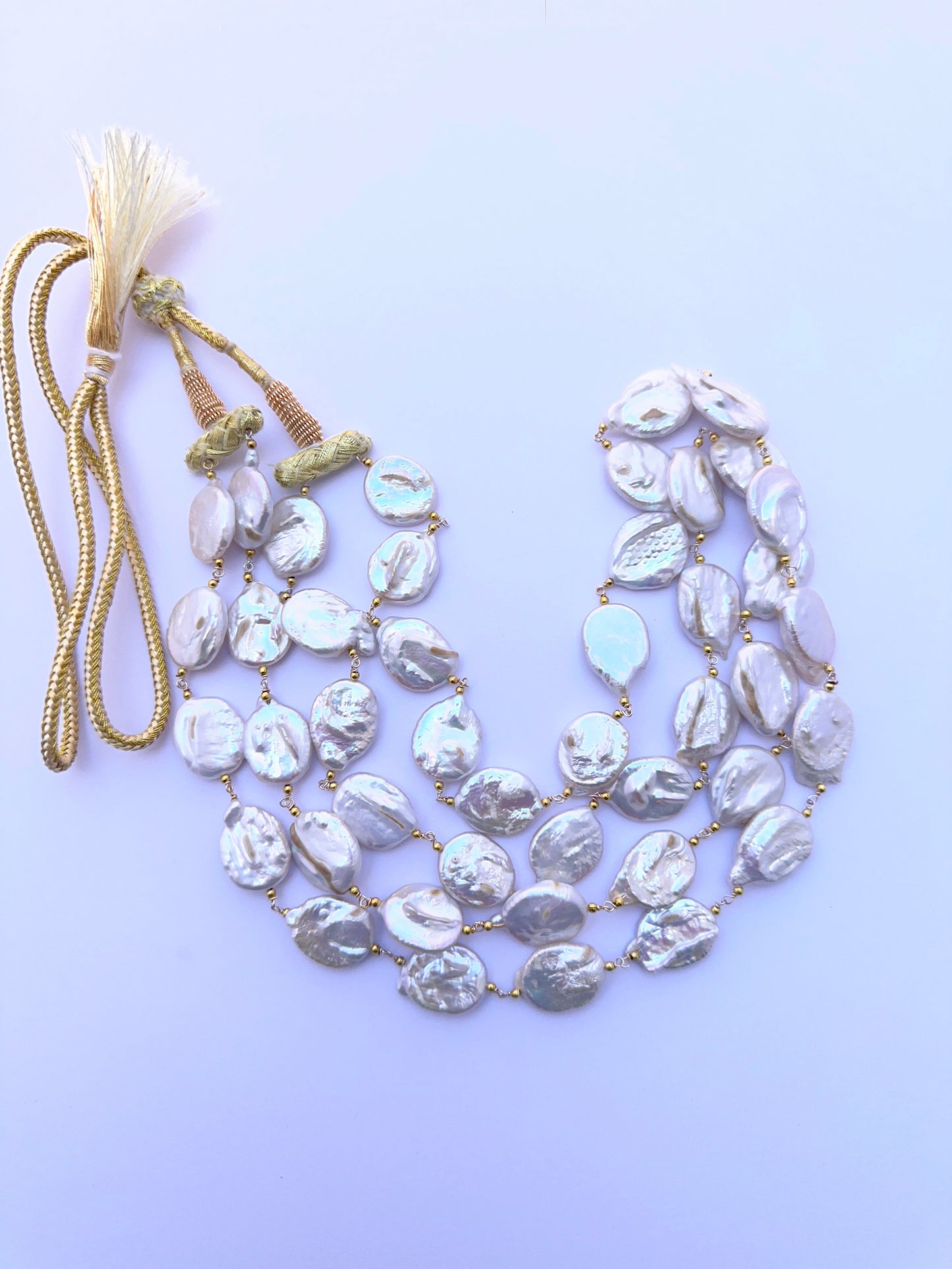 Two‑strand freshwater pearl necklace featuring large baroque coin pearls with natural texture.