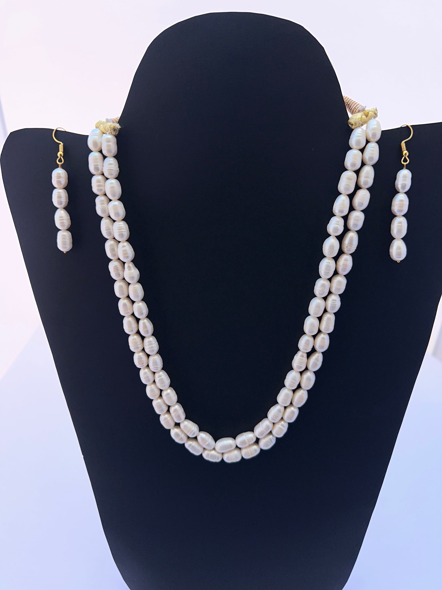 Elegant freshwater pearl necklace with textured oval pearls earrings designed for a classic jewellery look.