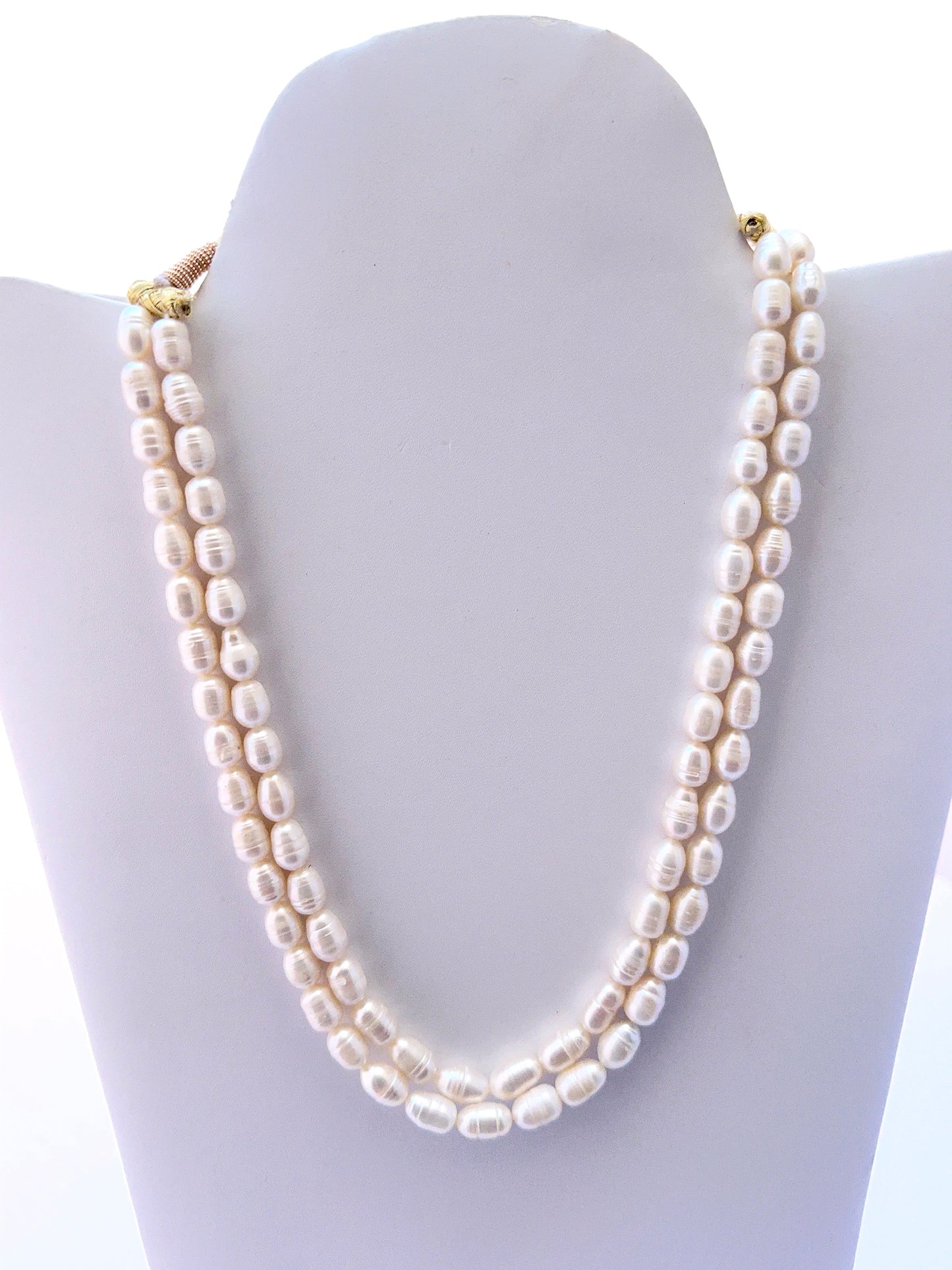 Two‑strand freshwater pearl necklace with oval textured pearls and a matching earrings option.
