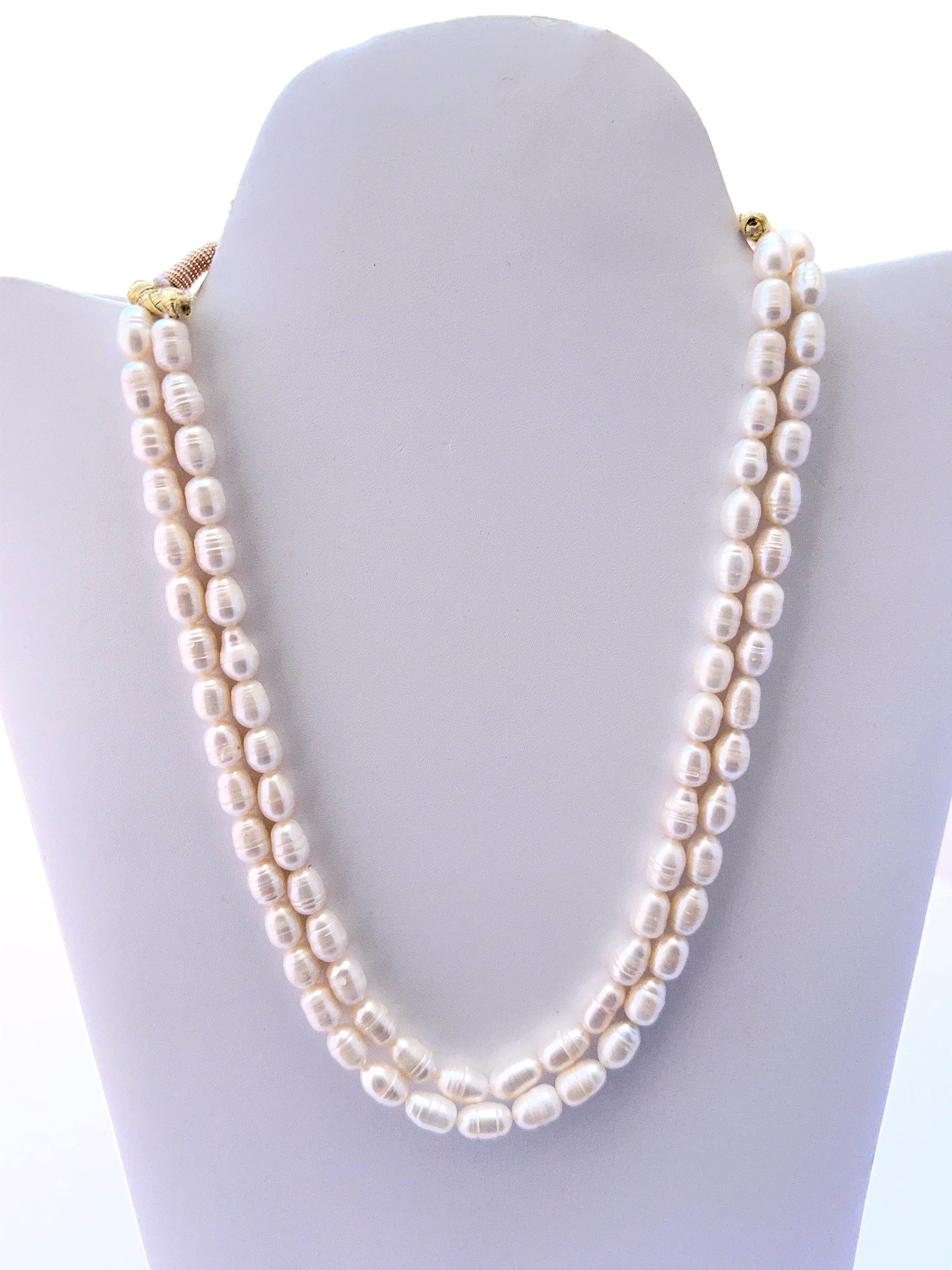 Two‑strand freshwater pearl necklace with oval textured pearls and a matching earrings option.