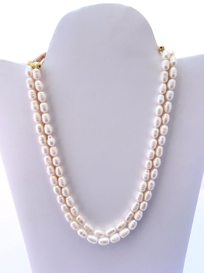 Two‑strand freshwater pearl necklace with oval textured pearls and a matching earrings option.