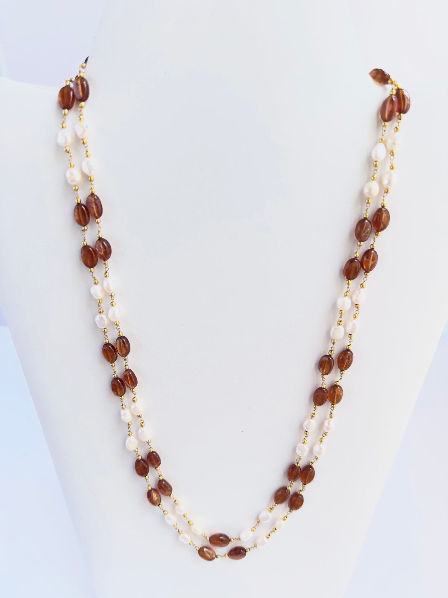 Elegant Hessonite and pearl necklace, two strands of smooth oval beads, 221 carats of brilliance.