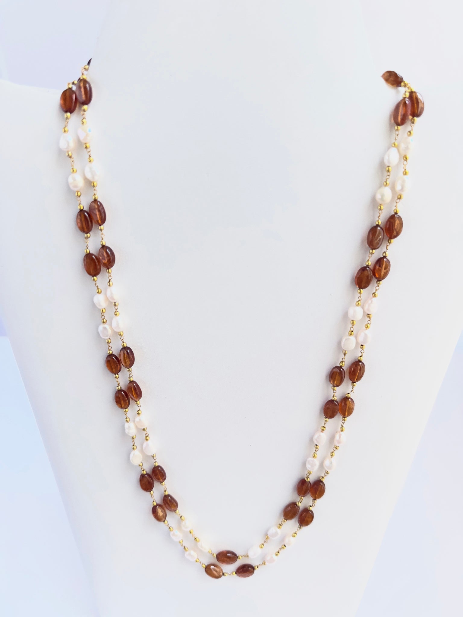 Elegant Hessonite and pearl necklace, two strands of smooth oval beads, 221 carats of brilliance.