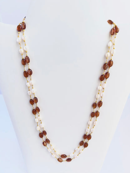 Elegant Hessonite and pearl necklace, two strands of smooth oval beads, 221 carats of brilliance.