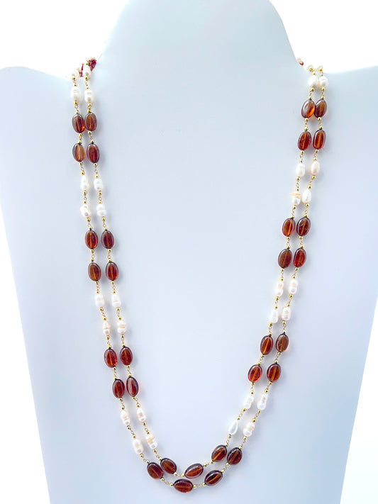Two‑strand hessonite and freshwater pearl necklace featuring smooth oval beads in warm tones.