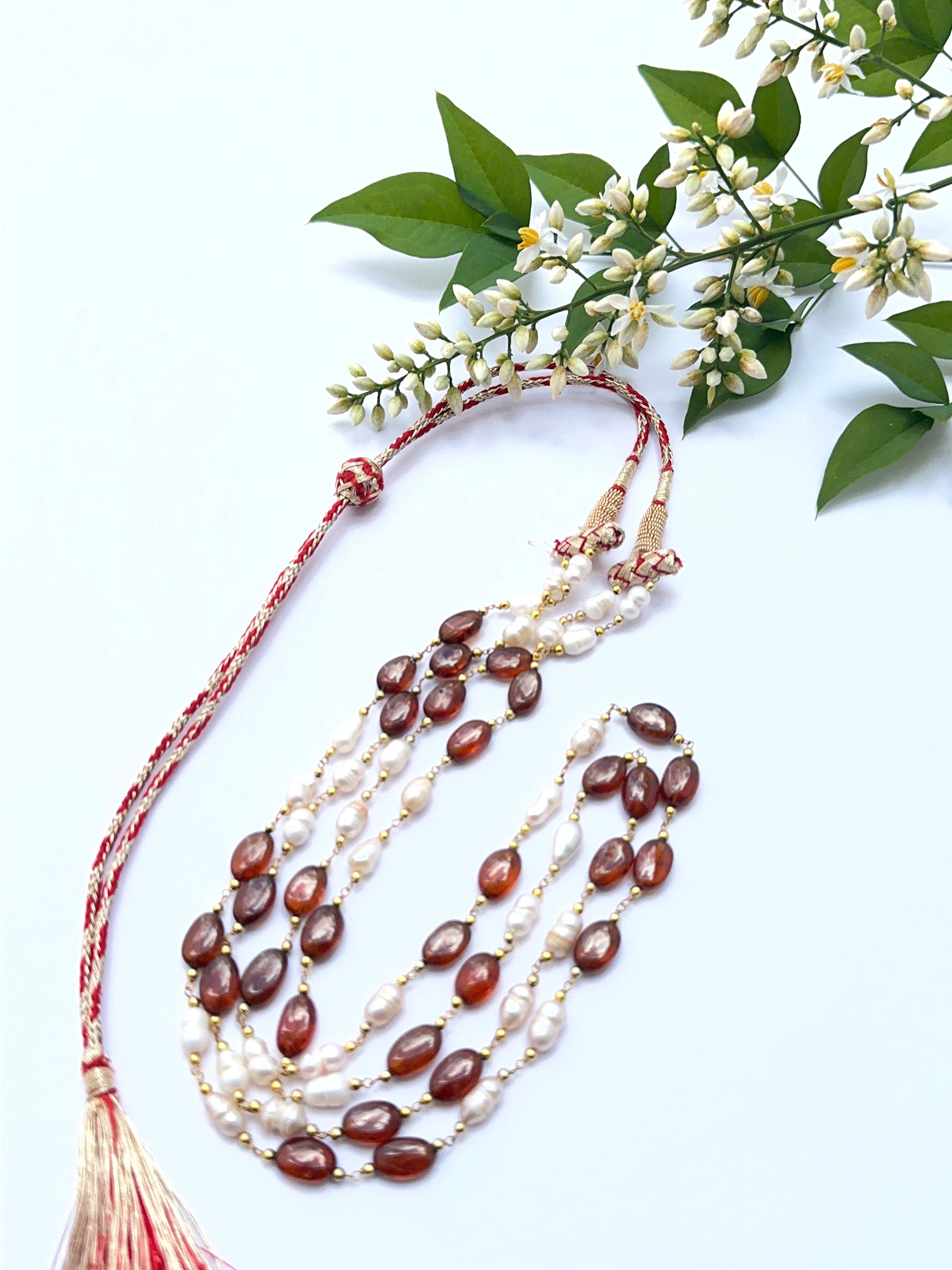 Hessonite and pearl necklace with smooth oval beads showing golden‑brown hues and soft lustre.