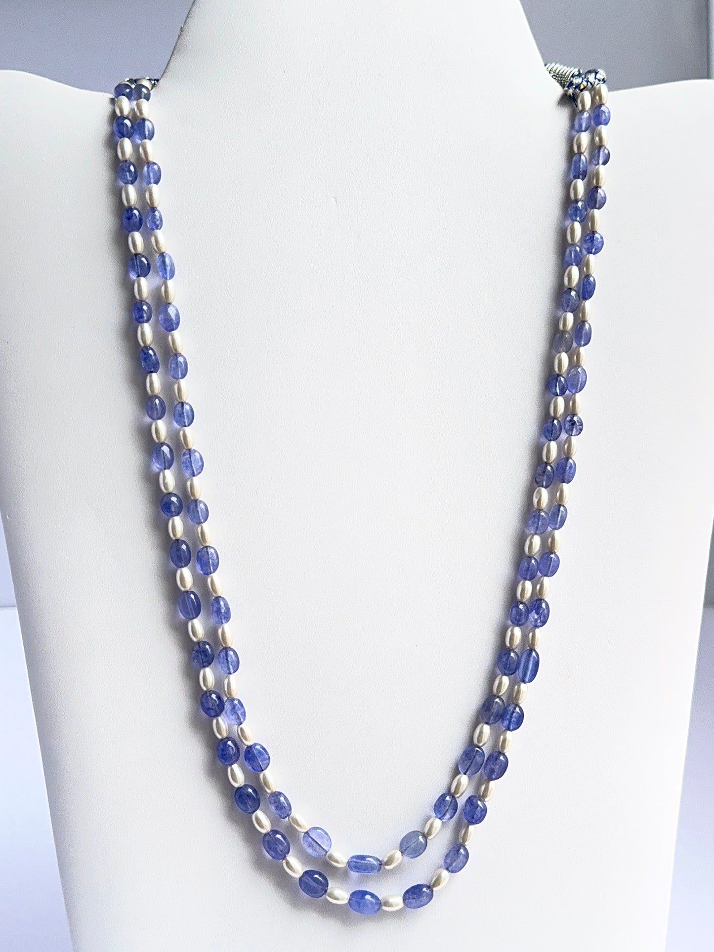 Two‑strand quartz and shell pearl necklace featuring smooth oval beads in soft neutral tones.