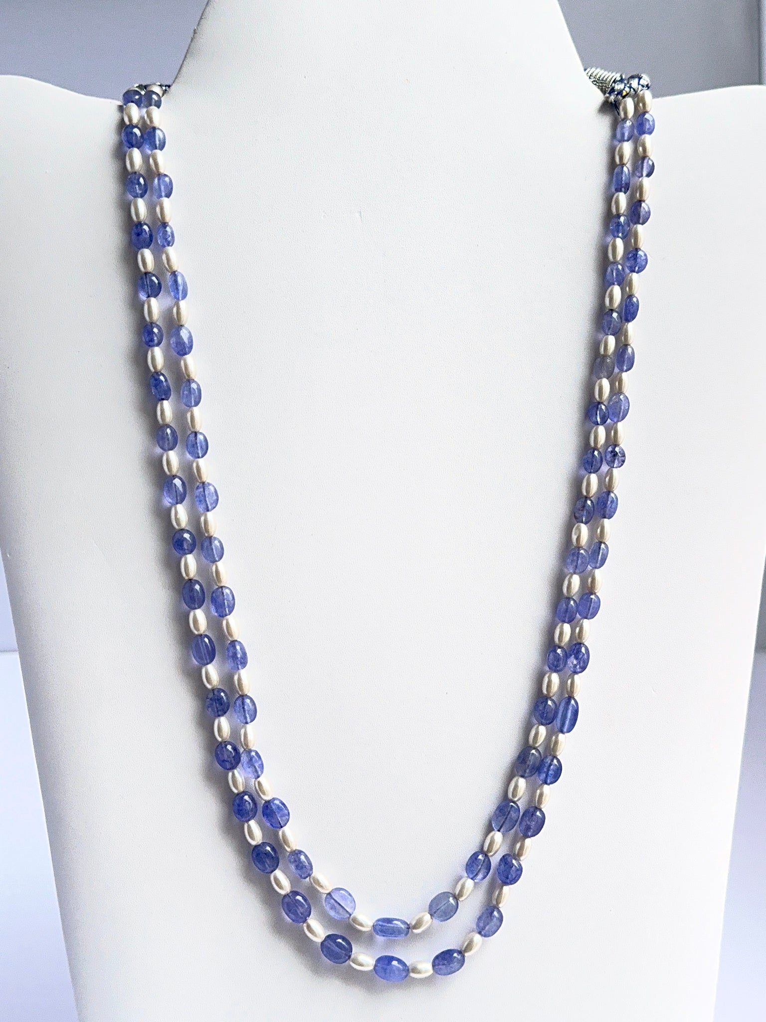 Two‑strand quartz and shell pearl necklace featuring smooth oval beads in soft neutral tones.