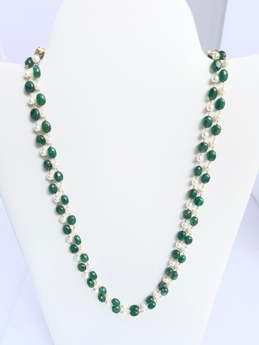 Close-up of quartz beads paired with luminous shell pearls, polished finish, arranged in strands.