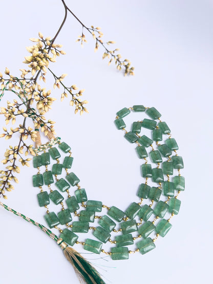 Quartz necklace with rectangular gemstones, two strands, 54–55cm length, silk tassel detail.