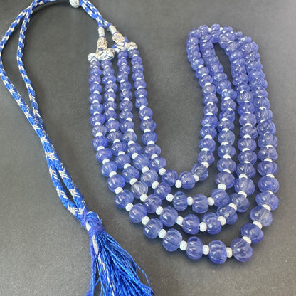 Close-up of melon-cut quartz beads, 304 carats, highlighting clarity and natural gemstone beauty.