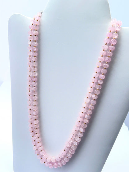 Rose quartz necklace with carved beads showing gentle colour and smooth polish.
