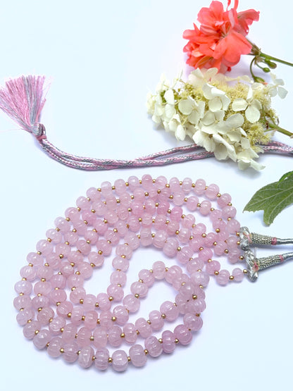 Elegant rose quartz necklace featuring pumpkin‑shaped beads in a layered design.