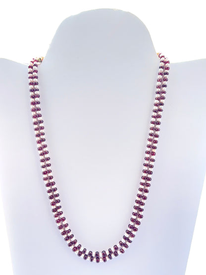 Two‑strand ruby and freshwater pearl necklace featuring smooth rondelle ruby beads.