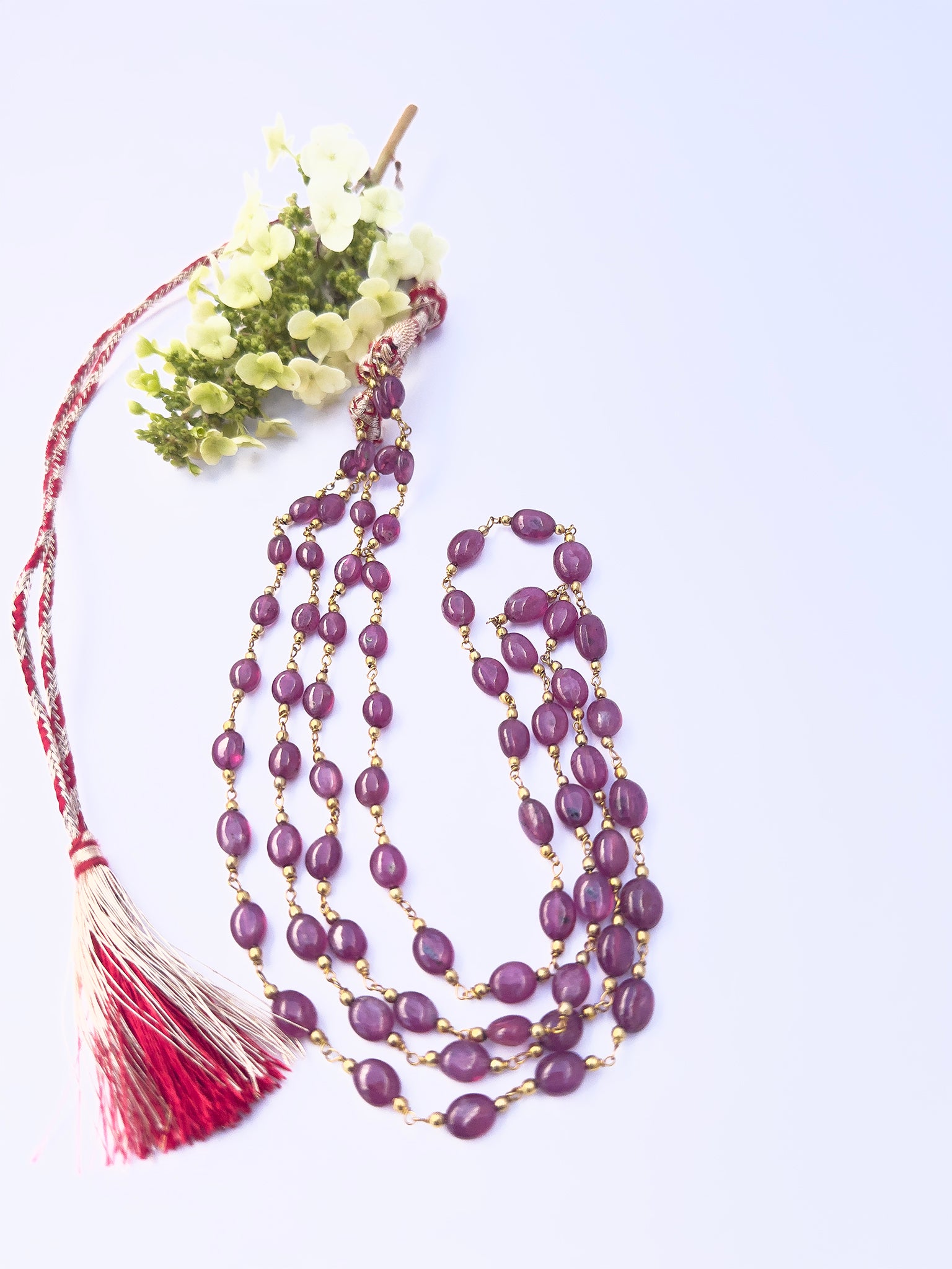 Ruby gemstone beads necklace, polished oval cut, radiant shine, tassel detail for styling.