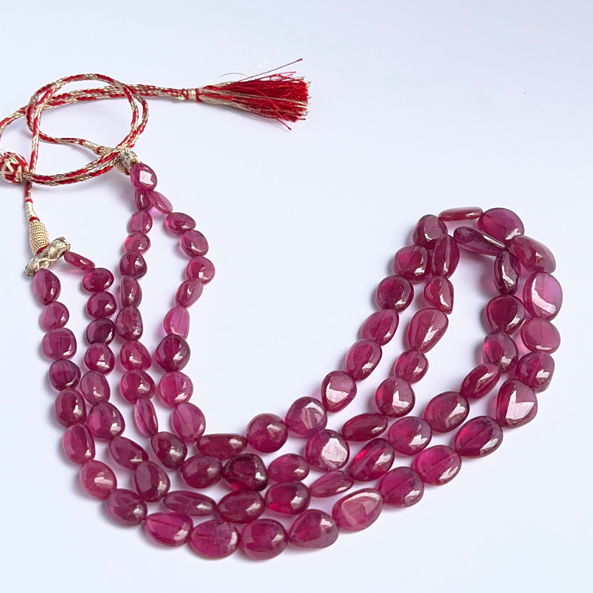 Ruby necklace with smooth tumble beads showing rich colour and shine.