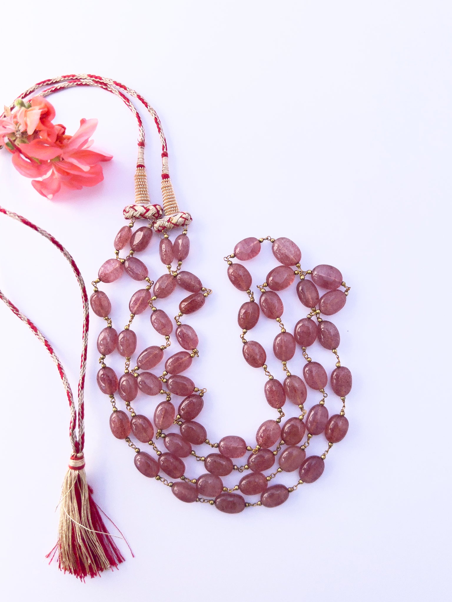 Strawberry Quartz necklace showcasing natural gemstone beads, smooth oval cut, versatile styling.