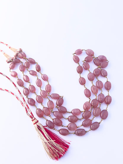 Strawberry Quartz gemstone beads necklace, polished oval cut, radiant shine, silk tassel detail.