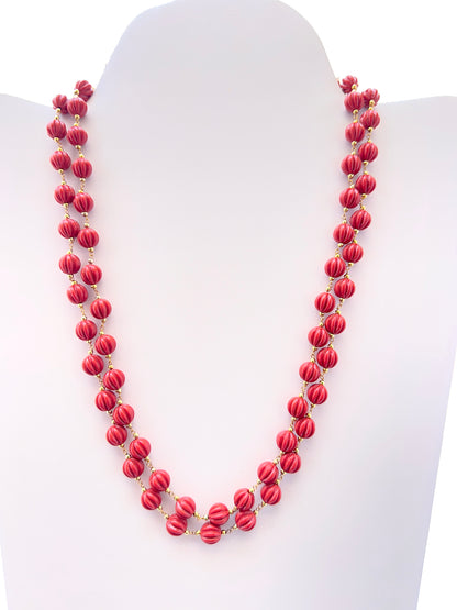 Two‑strand Taiwan coral necklace featuring carved pumpkin beads in vibrant red tones.