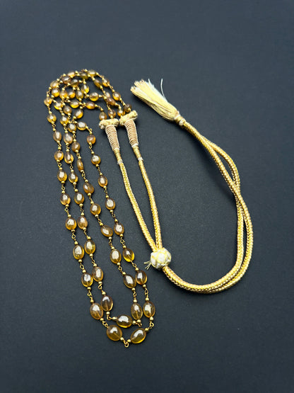 Elegant gemstone necklace featuring polished yellow sapphire beads in a layered design.