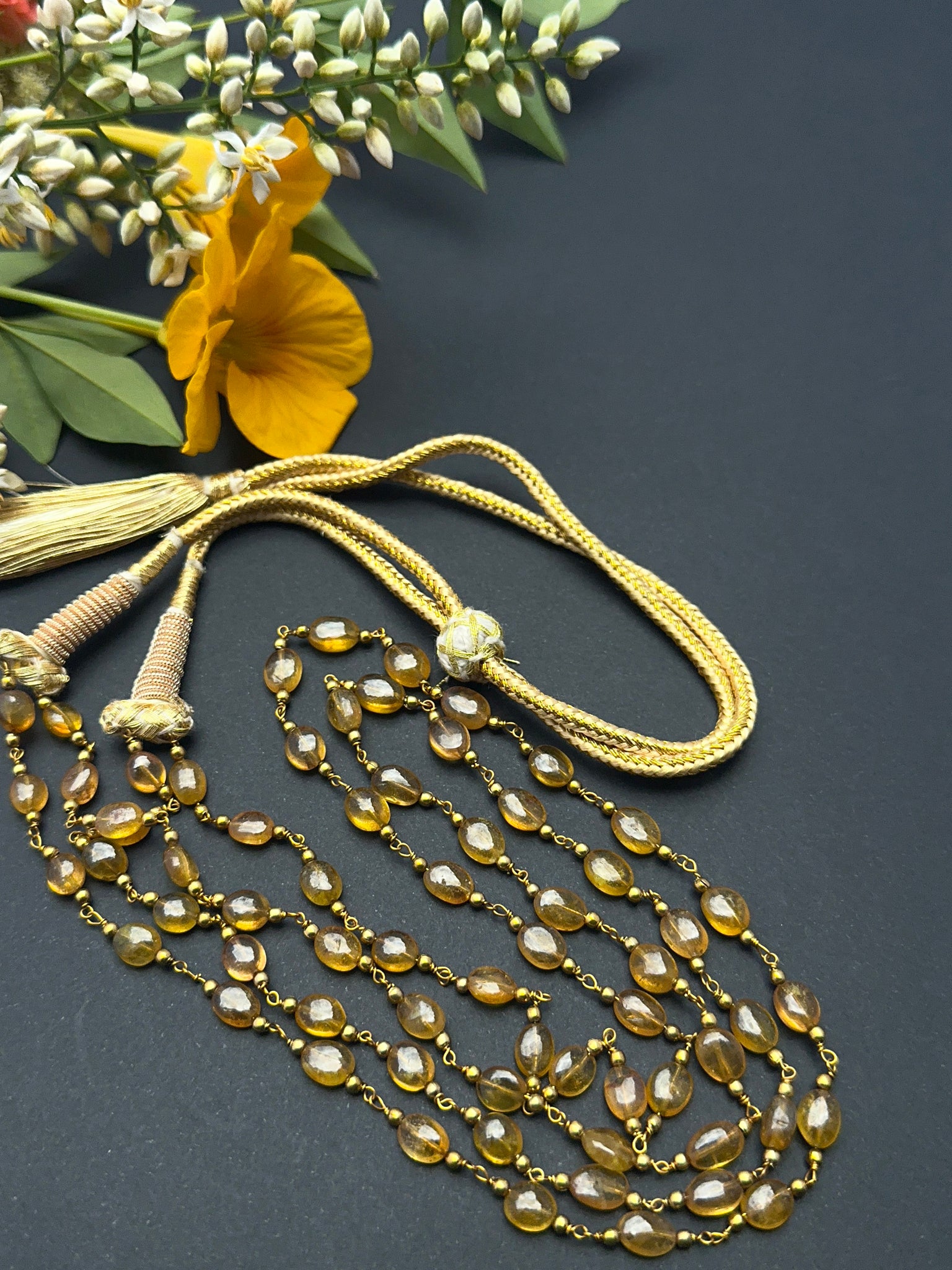 Yellow sapphire necklace with oval beads showing shine and warm colour.