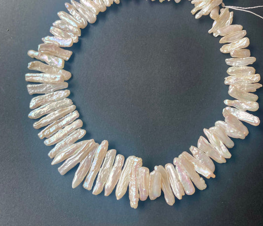 Baroque pearls with creamy white lustre, centre drilled and arranged on a 40cm strand.