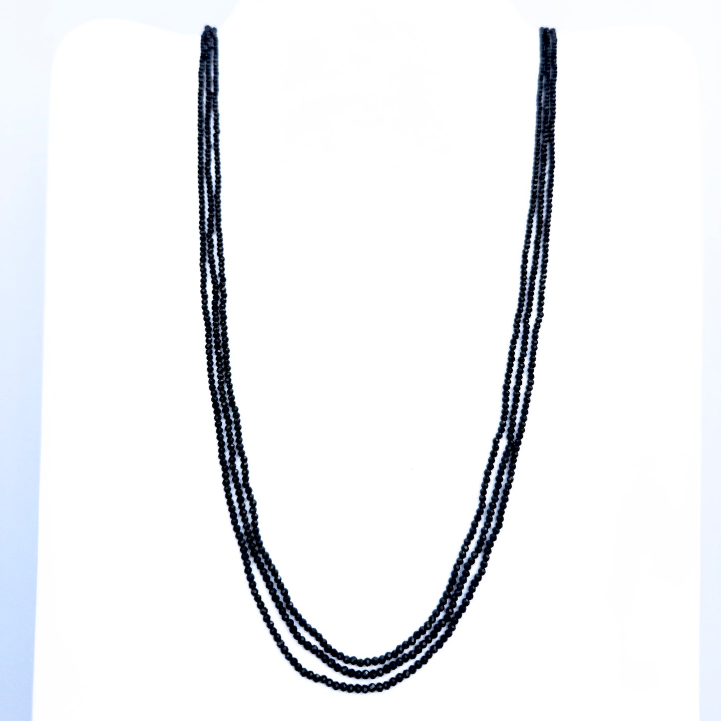 Three-strand Black Spinel necklace with faceted rondelle beads in deep black tones.
