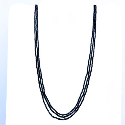 Three-strand Black Spinel necklace with faceted rondelle beads in deep black tones.