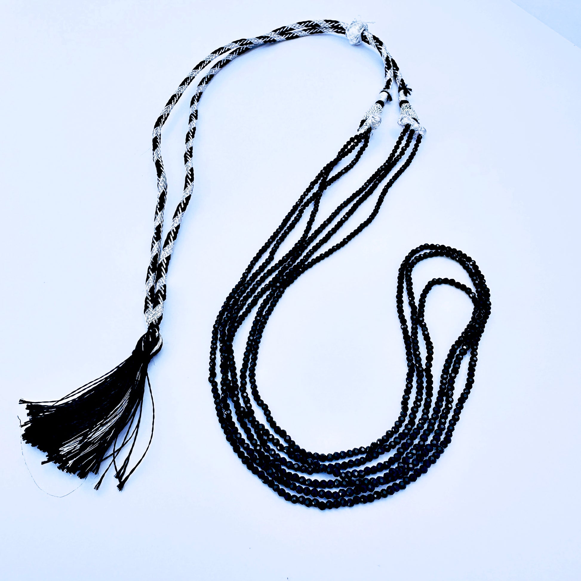 Handcrafted Black Spinel necklace with adjustable silk tassel and layered strands.