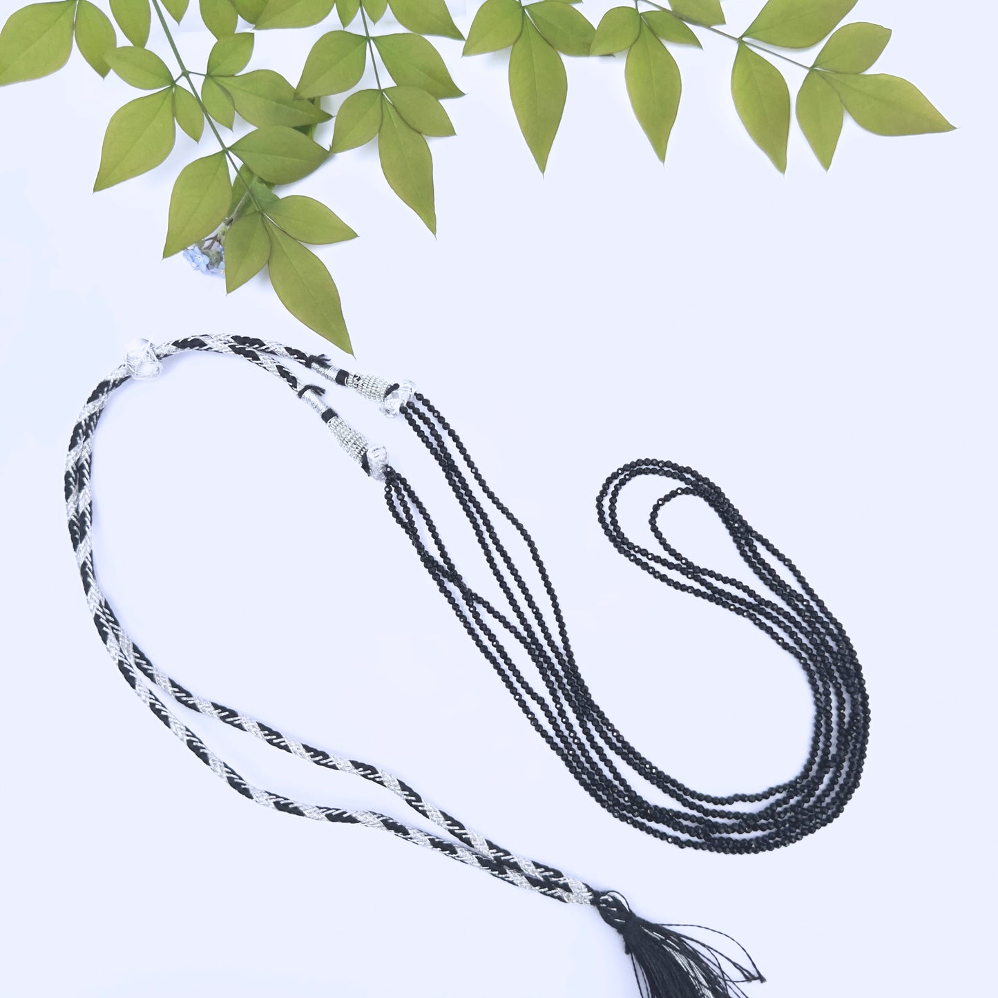 Close-up of faceted Black Spinel beads showing sparkle and polished finish.