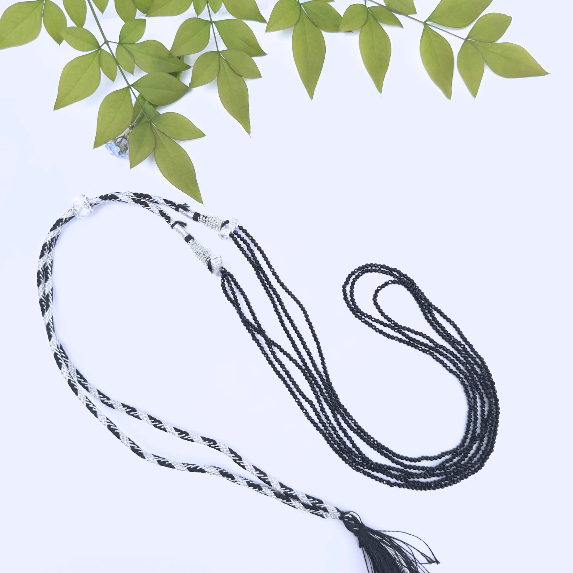 Close-up of faceted Black Spinel beads showing sparkle and polished finish.