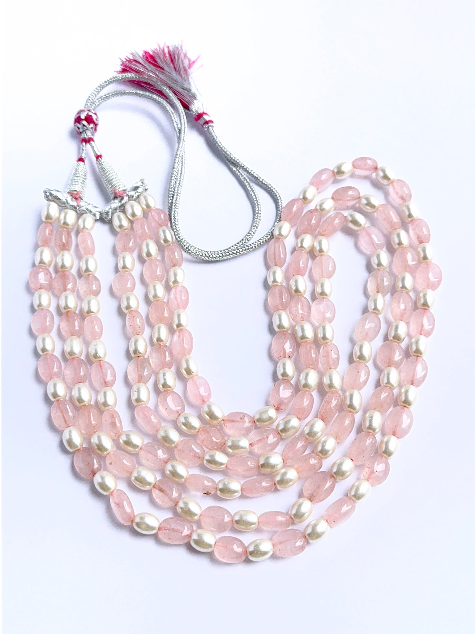 Elegant multi‑strand gemstone necklace featuring quartz and shell pearls