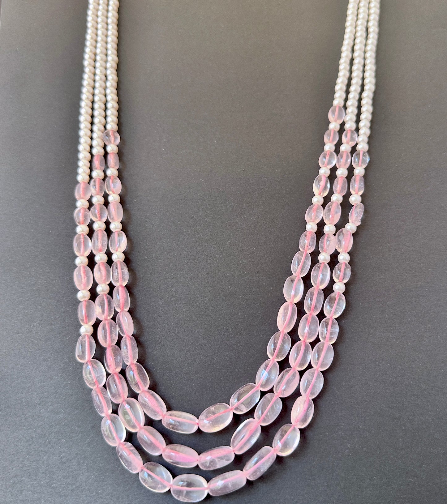 Natural gemstone beads with smooth finish and subtle sparkle in a multi-strand design.