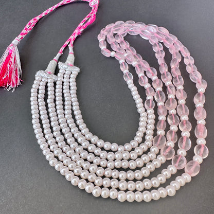 Layered necklace featuring natural gemstone beads in oval and round cuts with silk tassel finish.