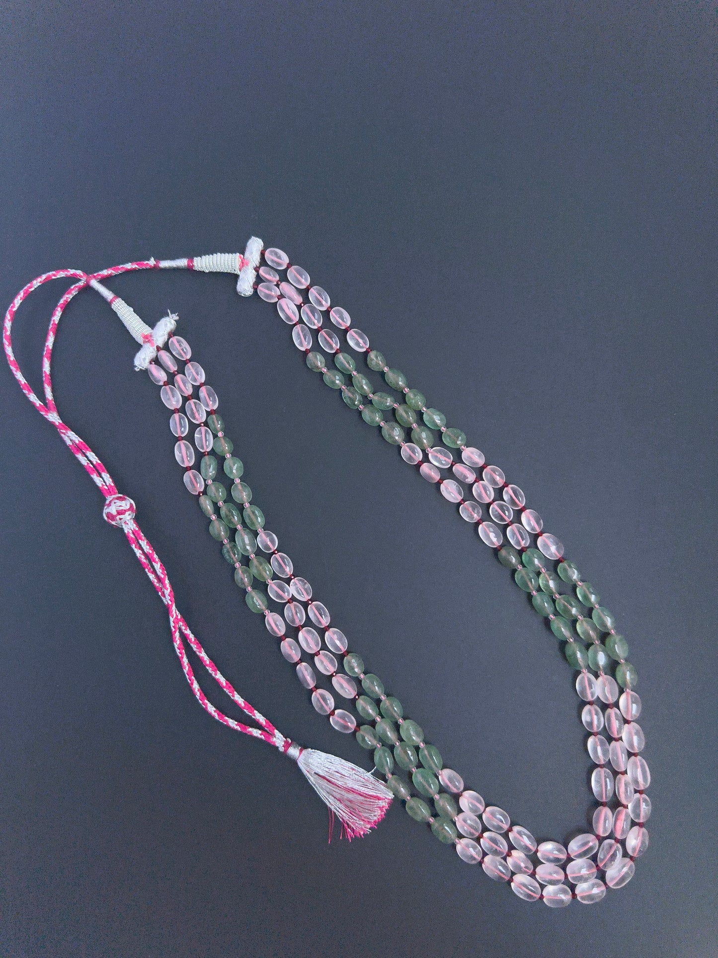 Quartz gemstone beads necklace, polished oval cut, radiant shine, silk tassel detail.
