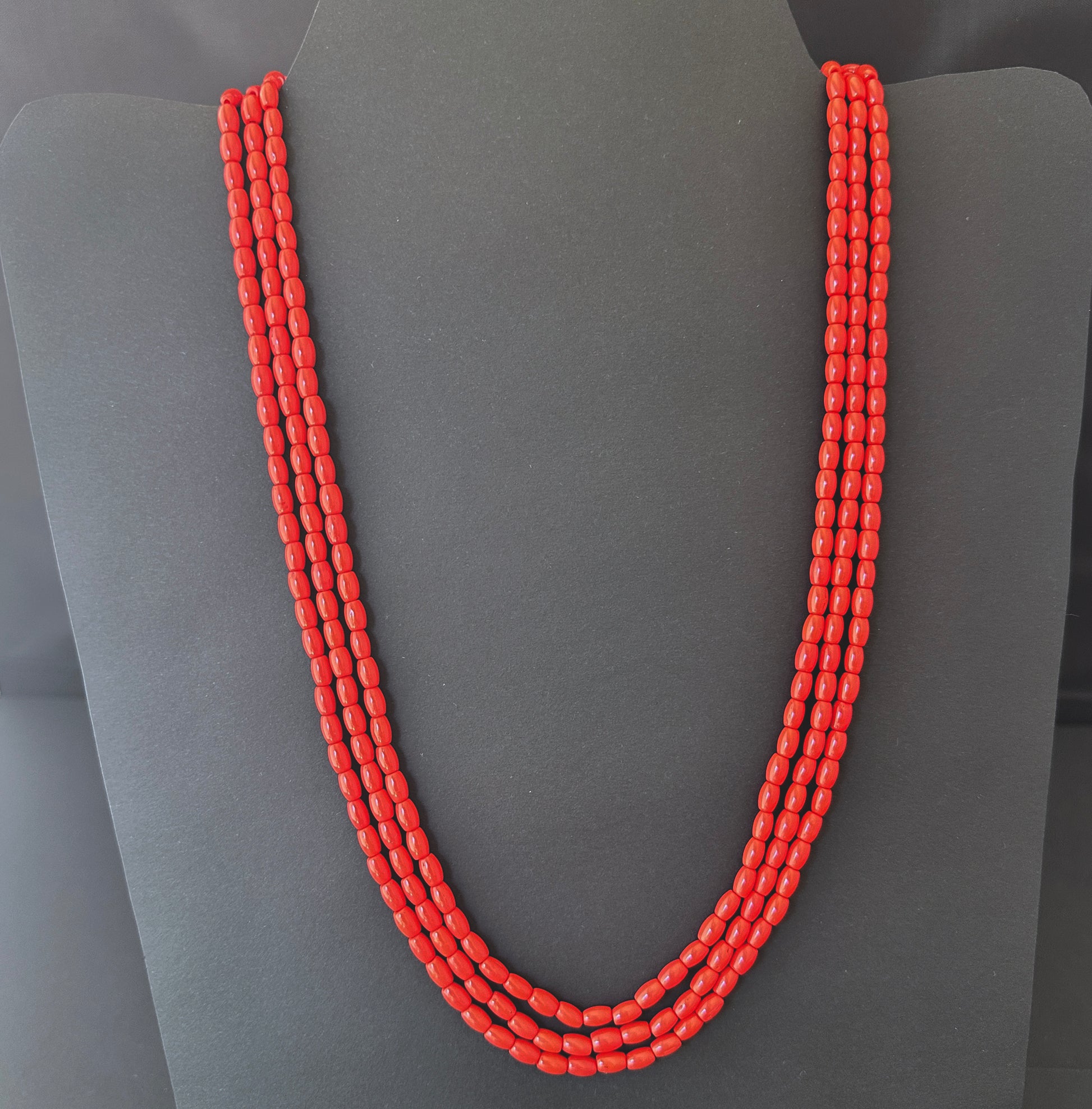 Necklace with delicate strands of Taiwan Coral beads, showcasing their smooth design.