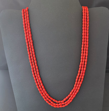 Necklace with delicate strands of Taiwan Coral beads, showcasing their smooth design.