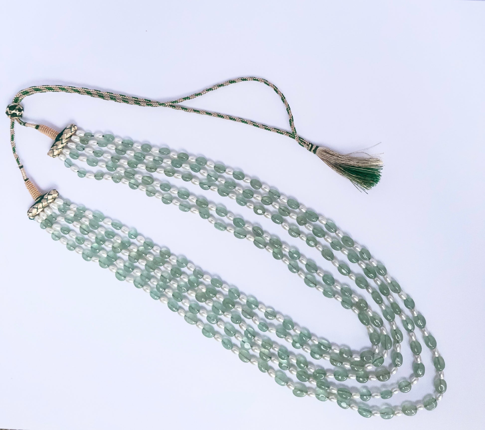 Quartz and shell pearl necklace, 568 carats of brilliance, finished with silk tassel accent.