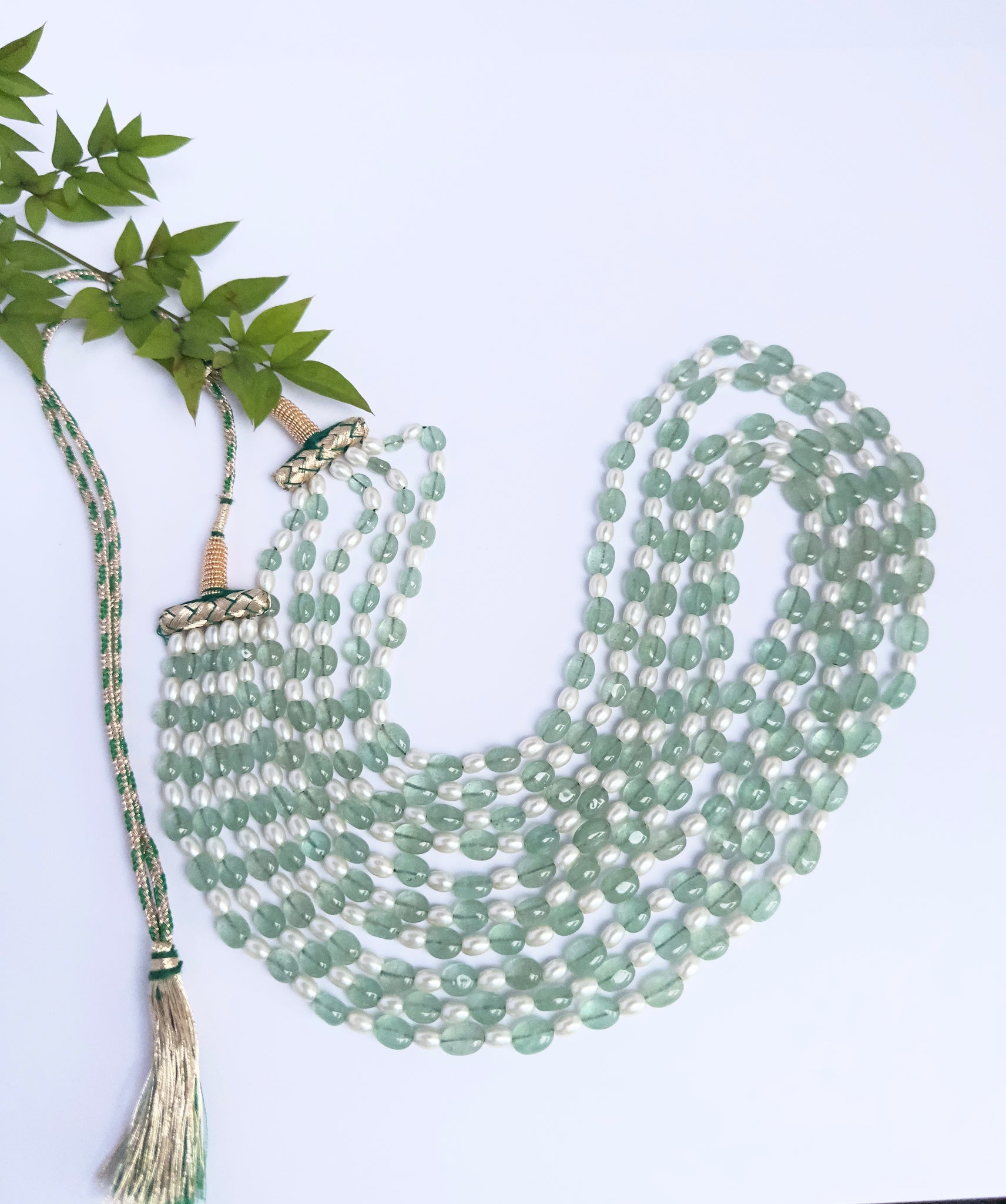 Necklace showcasing natural quartz and shell pearls, smooth oval cut, versatile styling.