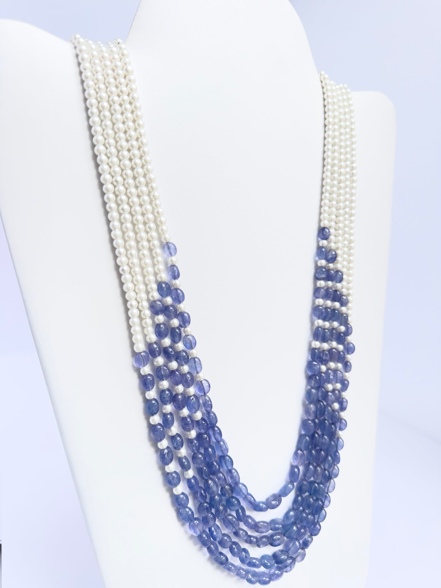 Elegant 5-strand necklace combining quartz and pearls, smooth oval design, 49–59cm adjustable length.